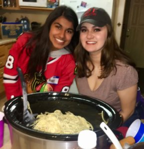 Brotherhood chair Jasmine Shah and Sarah Helm serve spaghetti at Food Friday